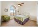 Bright bedroom with vaulted ceilings, ceiling fan, a large window and a green comfy chair at 6841 Longmeadow Dr, Pahrump, NV 89061