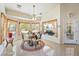 Bright breakfast nook with bay windows, tile flooring, decorative light fixture and table setting at 6841 Longmeadow Dr, Pahrump, NV 89061