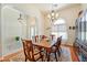 Home dining room featuring chandelier, arched doorways, wood floors, and large windows at 6841 Longmeadow Dr, Pahrump, NV 89061