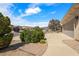 Long driveway with a two-car garage and mature landscaping at 6841 Longmeadow Dr, Pahrump, NV 89061