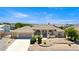 Beautiful one-story home featuring arched entry, desert landscaping, and an attached two-car garage at 6841 Longmeadow Dr, Pahrump, NV 89061