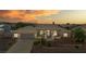 Dusk view of one-story home featuring tile roof, arched entry, desert landscaping, and two-car garage at 6841 Longmeadow Dr, Pahrump, NV 89061