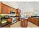 Updated kitchen with wooden cabinets, granite countertops, stainless appliances, and tile flooring at 6841 Longmeadow Dr, Pahrump, NV 89061
