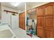 Well-equipped laundry room with wooden cabinets, sink, and washer dryer hookups at 6841 Longmeadow Dr, Pahrump, NV 89061