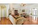 Bright living room featuring hardwood floors, stone fireplace, vaulted ceilings, and open floor plan at 6841 Longmeadow Dr, Pahrump, NV 89061