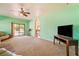 Comfortable living room featuring sliding glass door, carpet, and an open layout at 6841 Longmeadow Dr, Pahrump, NV 89061