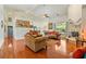 Open floor plan featuring a living room with a fireplace, hardwood floors, and abundant natural light at 6841 Longmeadow Dr, Pahrump, NV 89061