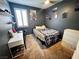 Cozy bedroom with a bed, desk, and dresser; well-lit by a window with shuttered blinds at 7035 Thistle Ridge St, Las Vegas, NV 89166