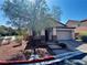 Charming single-story home with desert landscaping, stone accents, and a two-car garage at 7035 Thistle Ridge St, Las Vegas, NV 89166