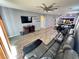 View of living room and kitchen with open floor plan, wood floors and decorative fan at 7035 Thistle Ridge St, Las Vegas, NV 89166