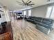 Large living room with wood floors, ceiling fan and seamlessly connected to kitchen and dining areas at 7035 Thistle Ridge St, Las Vegas, NV 89166