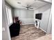 Flex space with wood floors, decorative fan, and mounted television perfect for a game room at 7035 Thistle Ridge St, Las Vegas, NV 89166