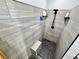 Luxurious shower featuring stylish tile work, a rain shower head, and a convenient built-in seat at 7035 Thistle Ridge St, Las Vegas, NV 89166