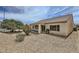 Expansive backyard with covered patio and desert landscaping, great for outdoor entertaining at 7465 Widewing Dr, North Las Vegas, NV 89084