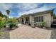 An outdoor grill and patio furniture sit on a paved patio next to a pool and desert landscaping at 7606 Grove Acre Ct, Las Vegas, NV 89131