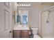 Bathroom features a sink with light wood cabinet, toilet, and walk-in shower at 7606 Grove Acre Ct, Las Vegas, NV 89131