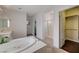 Bathroom boasts large soaking tub with jets, dual vanities, and walk-in closet at 7606 Grove Acre Ct, Las Vegas, NV 89131