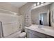 Bathroom featuring shower with glass door, and a vanity with light fixtures above at 7606 Grove Acre Ct, Las Vegas, NV 89131