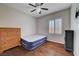 Bedroom featuring hardwood floors, a ceiling fan, and a window with shutters at 7606 Grove Acre Ct, Las Vegas, NV 89131