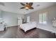 Bright bedroom features a ceiling fan, a vanity, and a dark wood floor at 7606 Grove Acre Ct, Las Vegas, NV 89131