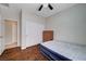Bright bedroom features wood floors, a ceiling fan, and a closet with ample storage space at 7606 Grove Acre Ct, Las Vegas, NV 89131