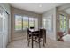 Cozy dining area with shutters, space for four, and tile flooring at 7606 Grove Acre Ct, Las Vegas, NV 89131