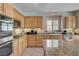 Kitchen showcases granite countertops, gas range, stainless steel appliances, and custom cabinetry at 7606 Grove Acre Ct, Las Vegas, NV 89131