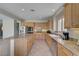 Open kitchen with a large island, stainless steel appliances, and granite countertops at 7606 Grove Acre Ct, Las Vegas, NV 89131