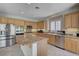 Bright kitchen with island, stainless steel appliances, granite counters, and light-colored cabinetry at 7606 Grove Acre Ct, Las Vegas, NV 89131