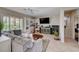 Comfortable living room with natural light, plush seating, and custom built-in shelving at 7606 Grove Acre Ct, Las Vegas, NV 89131
