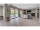 Spacious living room with tile flooring, a ceiling fan, and sliding glass doors to the pool at 7606 Grove Acre Ct, Las Vegas, NV 89131