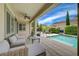 Covered patio featuring a seating area overlooking a pool in the backyard at 7606 Grove Acre Ct, Las Vegas, NV 89131
