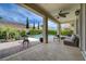 Covered patio features seating area, ceiling fan, and view of the backyard pool at 7606 Grove Acre Ct, Las Vegas, NV 89131