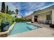 Tranquil swimming pool surrounded by a patio, tropical plants and shade trees at 7606 Grove Acre Ct, Las Vegas, NV 89131