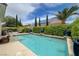 View of a backyard pool that is surrounded by lush, mature landscaping at 7606 Grove Acre Ct, Las Vegas, NV 89131
