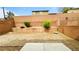 Backyard with a retaining wall, landscaping, and a concrete patio at 7815 Shingle Beach St, Las Vegas, NV 89166