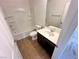 Bathroom featuring tiled floors, a bathtub, and a single sink vanity at 7815 Shingle Beach St, Las Vegas, NV 89166