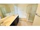 Bathroom featuring double sinks, granite countertops, a bathtub, and a shower with a glass enclosure at 7815 Shingle Beach St, Las Vegas, NV 89166