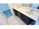 Modern bathroom with double sink vanity, tiled floor, and separate door to the toilet at 7815 Shingle Beach St, Las Vegas, NV 89166