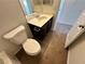 Bathroom featuring tiled floors, a toilet, and a single sink vanity at 7815 Shingle Beach St, Las Vegas, NV 89166
