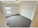 Bedroom featuring plush carpet, neutral walls and a bright window at 7815 Shingle Beach St, Las Vegas, NV 89166