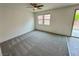 Neutral bedroom offering new carpet, lots of light, and slider door access to outside at 7815 Shingle Beach St, Las Vegas, NV 89166