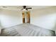 Spacious bedroom featuring neutral carpet, ceiling fan, and access to an ensuite bathroom at 7815 Shingle Beach St, Las Vegas, NV 89166