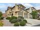 View of the home's facade showcasing its architectural style, desert landscaping, and street sign at 7815 Shingle Beach St, Las Vegas, NV 89166