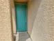 Close-up of a teal front door showing its design and the surrounding exterior texture at 7815 Shingle Beach St, Las Vegas, NV 89166