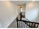 Hallway with carpeted floors and white walls leads to various rooms at 7815 Shingle Beach St, Las Vegas, NV 89166