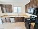 Kitchen showcasing wood cabinets, granite countertops, a stainless steel sink, and black appliances at 7815 Shingle Beach St, Las Vegas, NV 89166