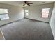 Spacious living room with carpet, ceiling fan, and large windows at 7815 Shingle Beach St, Las Vegas, NV 89166