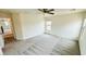 Living room featuring plush carpet, ceiling fan, and bright windows at 7815 Shingle Beach St, Las Vegas, NV 89166