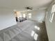 Large living room with multiple windows and a ceiling fan, connecting to the upper level landing at 7815 Shingle Beach St, Las Vegas, NV 89166